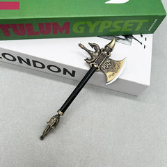 Anime-style zinc alloy axe replica collectible with black handle, displayed on books, BlacksmithSONG.