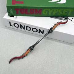 Anime-style zinc alloy double-bladed collectible weapon replica on books, BlacksmithSONG display.