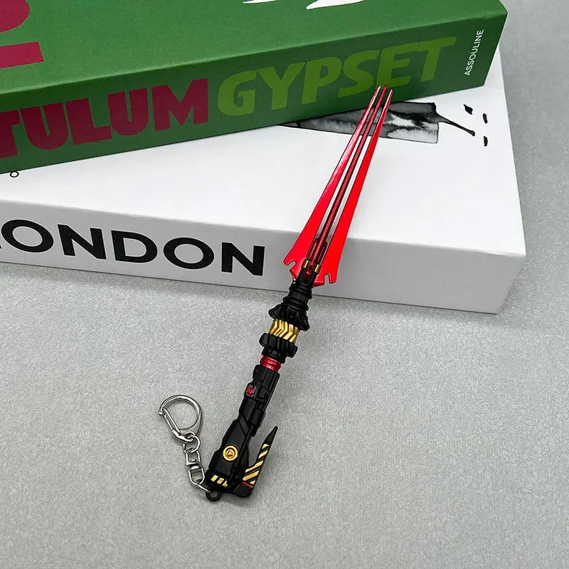 Anime-style zinc alloy trident keychain collectible on books, BlacksmithSONG cosplay replica.