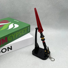 Anime-style zinc alloy weapon replica with red blade on display stand, collectible keychain from BlacksmithSONG.
