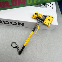 Anime-style yellow zinc alloy axe keychain collectible on table, BlacksmithSONG display.