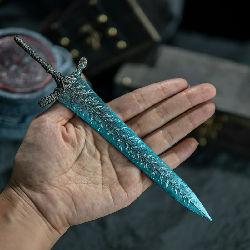 See the Dark Moon Greatsword in hand!  This 22cm metal replica captures the intricate leaf patterns and magical blue sheen of the legendary Elden Ring weapon. Solid zinc alloy construction gives it a premium weight. A standout collectible for your shelf or small-scale cosplay.
