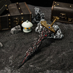 Wield the power of Destined Death. ?? This Maliketh's Black Blade replica captures the terrifying beauty of the Black Blade's colossal sword. Featuring the iconic cracked blade with red accents and a detailed gold hilt. A massive metal collectible for any Elden Ring fan's desk setup.