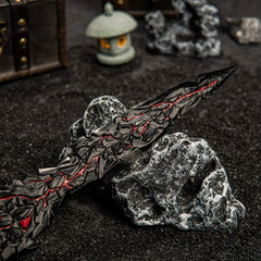 Close-up detail of the jagged blade tip of Maliketh's Black Blade, showing the red and black cracked texture.