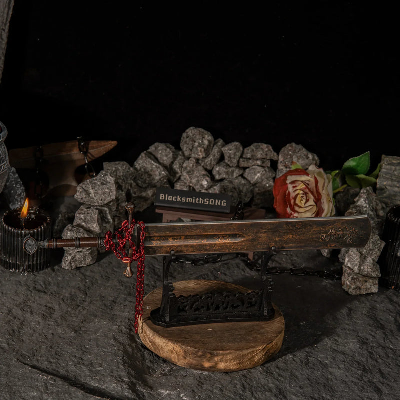 A tribute to the Shaded Castle. ?? This Marais Executioner's Sword metal replica sits menacingly on a custom stand, surrounded by iron chains and roses. The perfect gaming desk decoration for Elden Ring players who master the Arcane arts and the Eochaid's Dancing Blade. - Large display rack