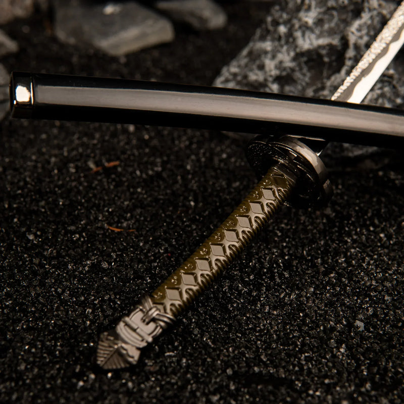 A masterpiece of Carian craftsmanship. Zoom in on the intricate details of the Moonveil Katana replica. From the traditional wrapped handle to the sleek black scabbard, every element is crafted from high-quality zinc alloy. The perfect addition to any Elden Ring collection or samurai display.