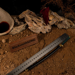 BlacksmithSONG 1:6 anime-style katana replica with ruler, displayed on rustic sand and rocks