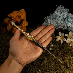 Hand holding 1:6 anime-style zinc alloy sword replica with gold detail, for display or cosplay