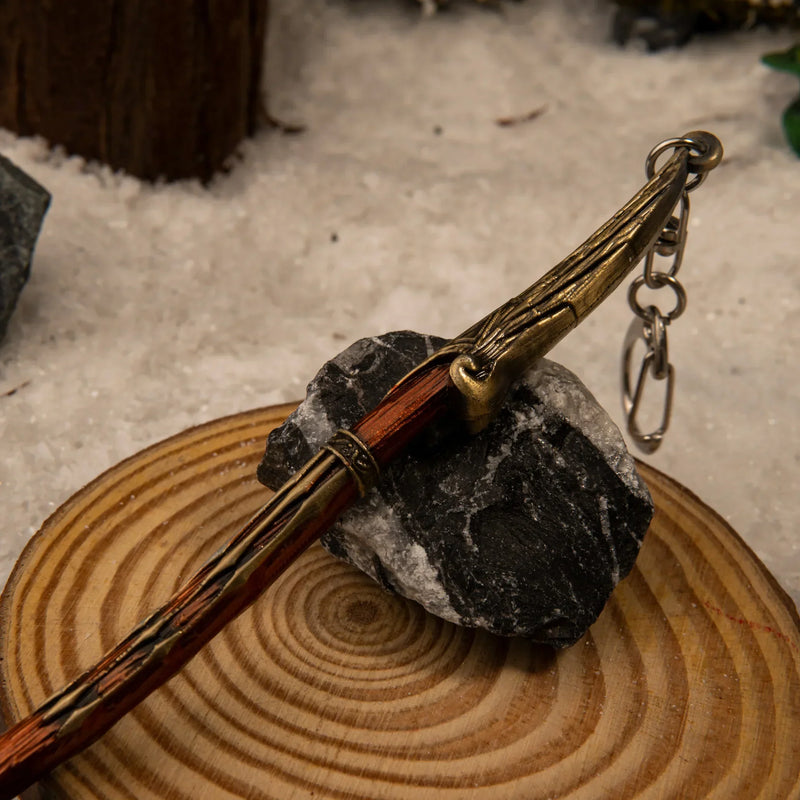 Leviathan Axe replica — axe head and wrapped haft close-up on a wood round.