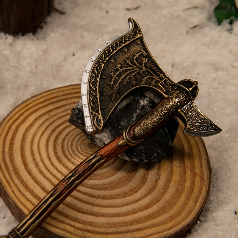 Leviathan Axe replica — axe head close-up on a wood round, showing the scrollwork detail.