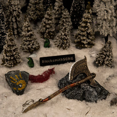 Leviathan Axe replica (16cm die-cast zinc alloy axe) — hero shot in a snowbound pine forest diorama, by BlacksmithSONG.