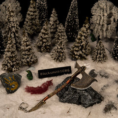 Leviathan Axe replica — second angle in the handcrafted snowy forest set with a gold handprint stone.