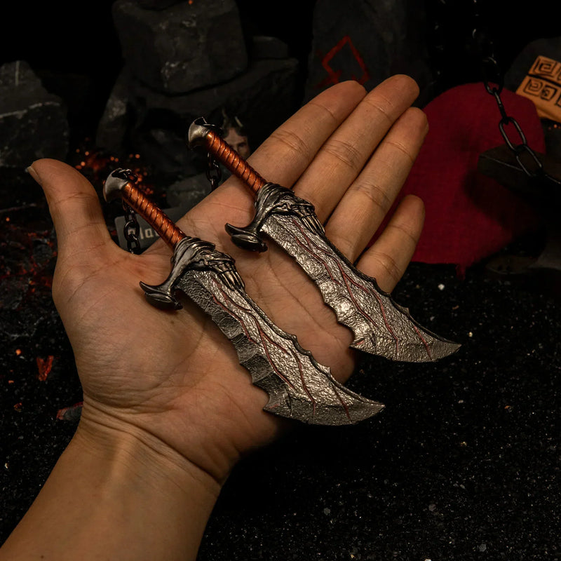 Blades of Chaos replica (13cm die-cast zinc alloy twin blades) — held in hand for scale.