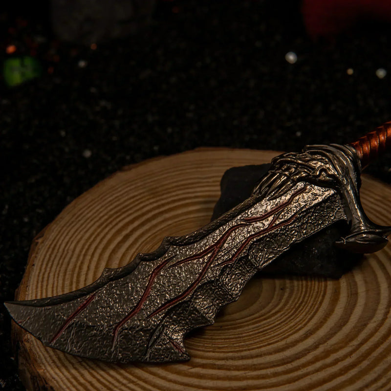 Blades of Chaos replica — clawed guard and wrapped grip in close-up on a wooden base.