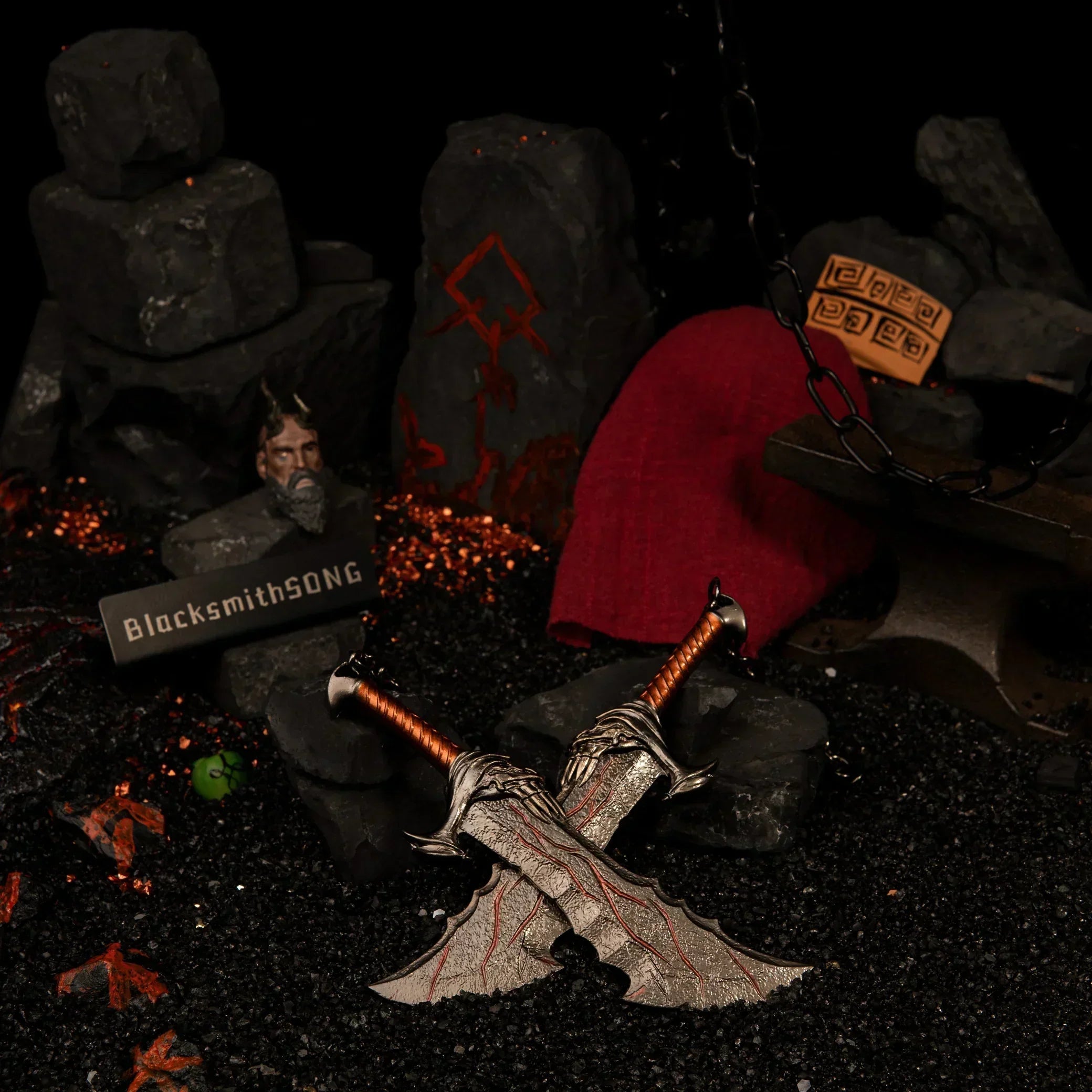 Close-up of metal Blades of Chaos miniature props showing the fiery red cracking details on the blade surface.