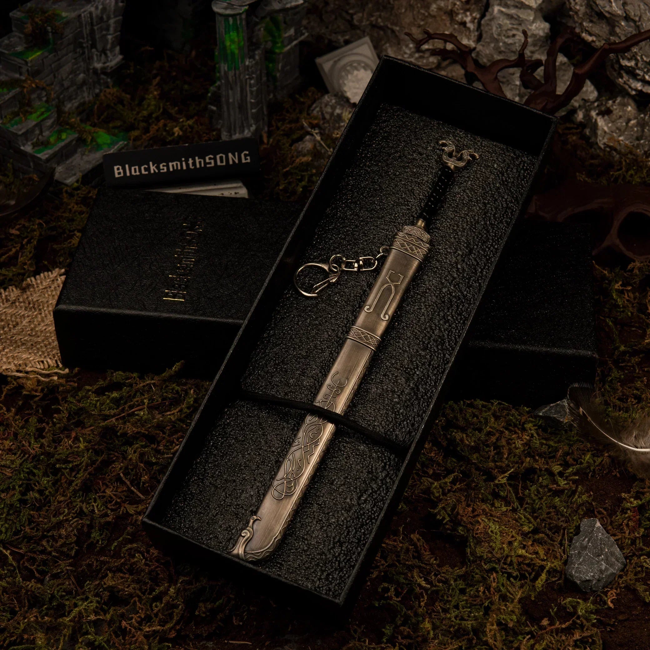 A metal Thrungva sword replica resting securely inside a black gift box packaging.