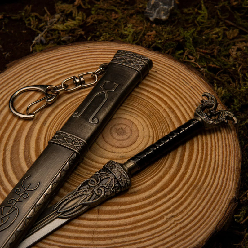 Thrungva replica — pommel, guard, and scabbard laid on a wood display base.
