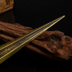 Close-up macro shot of the golden blade tip of the sword replica.