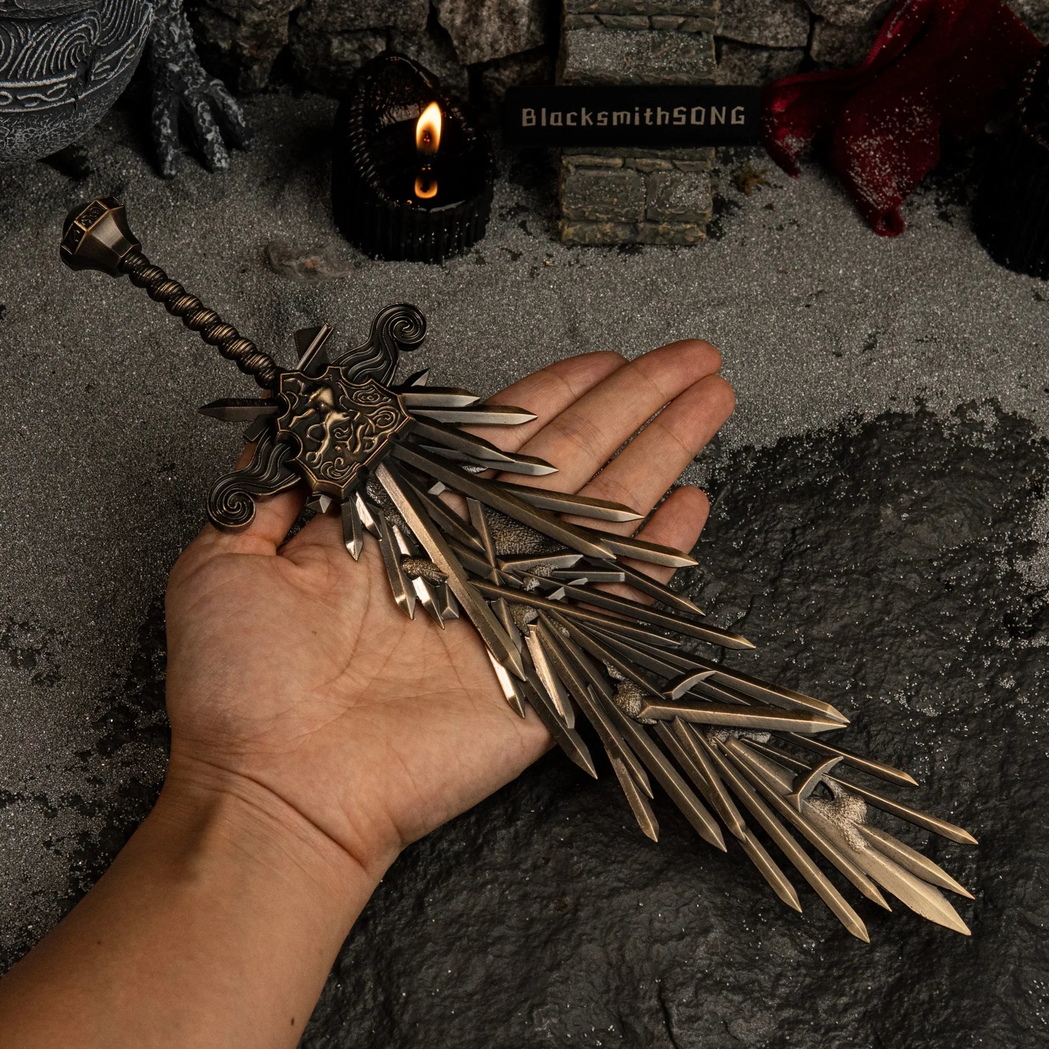 A hand holding the Grafted Blade Greatsword miniature to show scale. The replica is roughly hand-length.