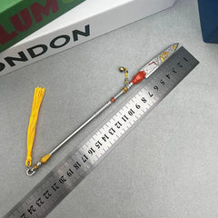 1:6 anime-style zinc alloy spear replica with yellow tassel beside a ruler on gray surface