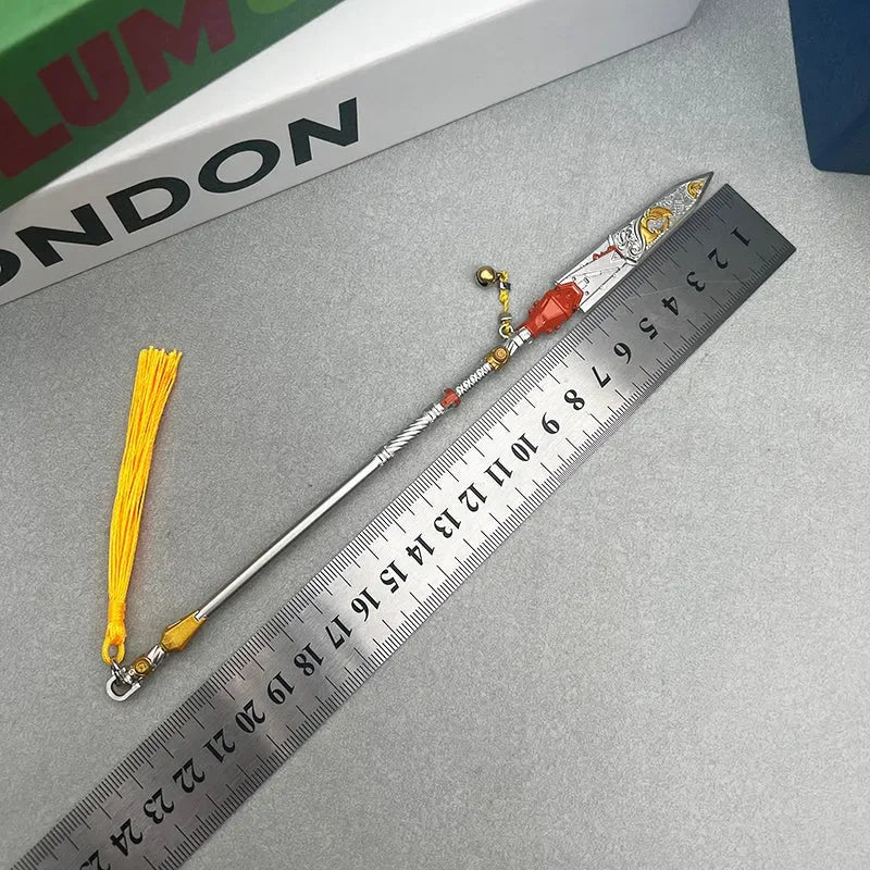 1:6 anime-style zinc alloy spear replica with yellow tassel beside a ruler on gray surface