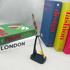 1:6 anime-style zinc alloy weapon replica on stand, displayed with colorful books