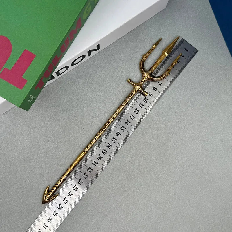 Gold 1:6 anime-style zinc alloy trident replica beside ruler on desk, BlacksmithSONG collectible