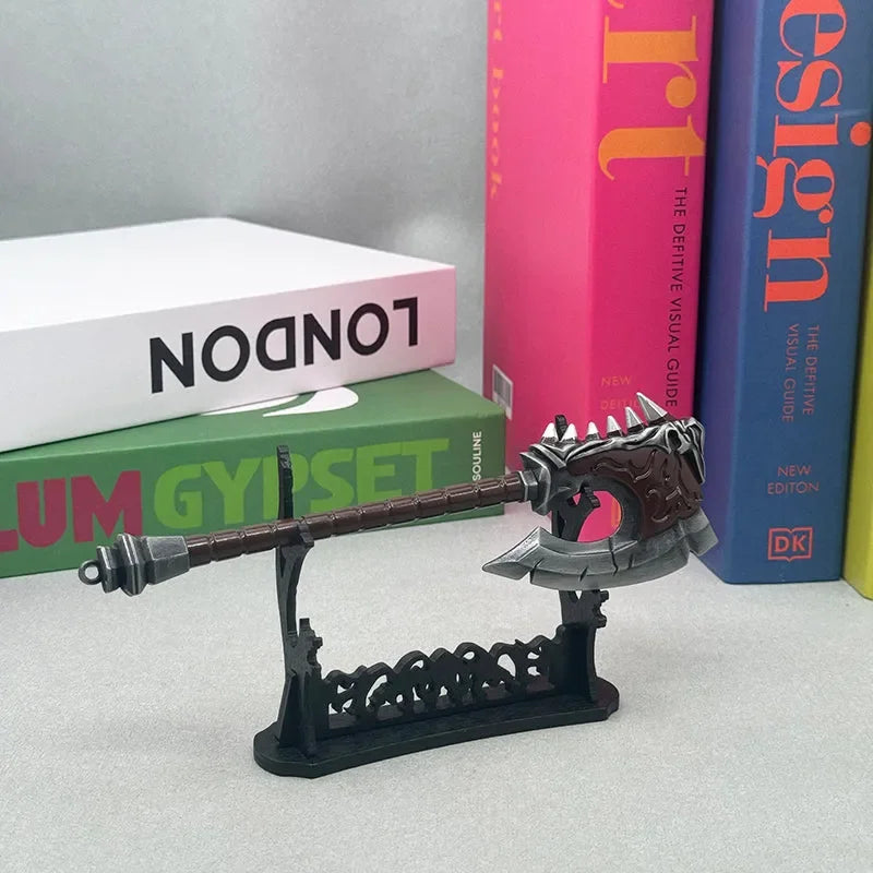 Anime-style zinc alloy axe replica on display stand, with colorful books background.