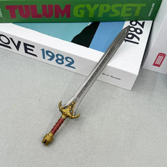 Anime-style zinc alloy sword replica with ornate gold hilt on tabletop, BlacksmithSONG collectible.
