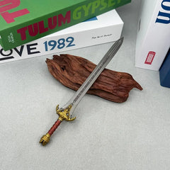 Anime-style zinc alloy sword replica with gold hilt on wood, BlacksmithSONG collectible
