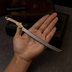 Gold-Hilt Serrated Katana replica (22cm die-cast zinc alloy katana) — held in hand for scale.