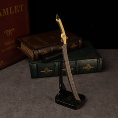 Gold-Hilt Serrated Katana replica — on the vertical display stand.