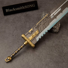 Buster Sword R5 replica — hilt close-up: gold crossguard and diamond-studded dark grip.