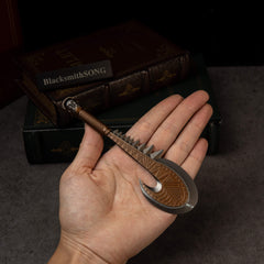 Patu replica (15cm die-cast zinc alloy war club) — held in hand for scale.