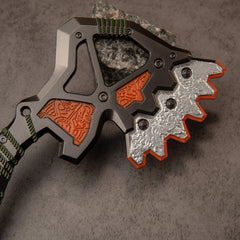 War Club replica — close-up of the open lattice frame, copper-orange panels and serrated silver crest.