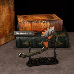 War Club replica — displayed on the large display stand with old hardcover books behind.