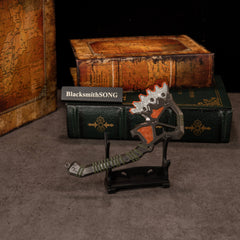 War Club replica — displayed on the small display stand with old hardcover books behind.