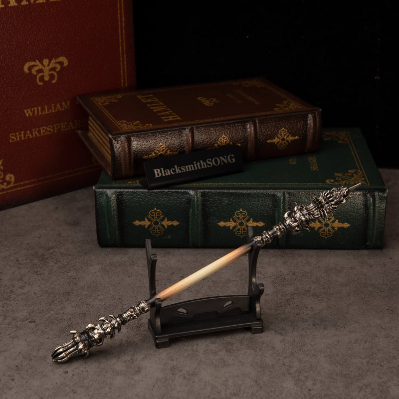 Chitin Staff replica — resting on the small display stand.