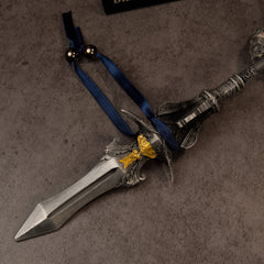 Chu-Bai Spear replica — close-up of the ridged spearhead, gold-toned collar, scrollwork guard and navy ribbon.