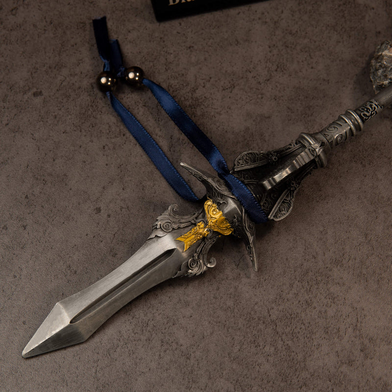 Chu-Bai Spear replica — close-up of the ridged spearhead, gold-toned collar, scrollwork guard and navy ribbon.