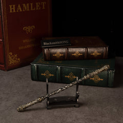Cloud-Patterned Stone Staff replica — resting on the small display stand.