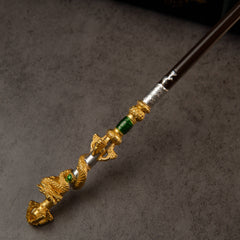 Loongwreathe Staff replica — close-up of a gold-toned dragon coil and green band on the shaft.