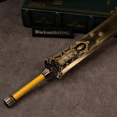 Zodiac Tiger Sabre replica — hilt close-up with a relief figure in a flame-edged frame and a yellow wrapped grip.