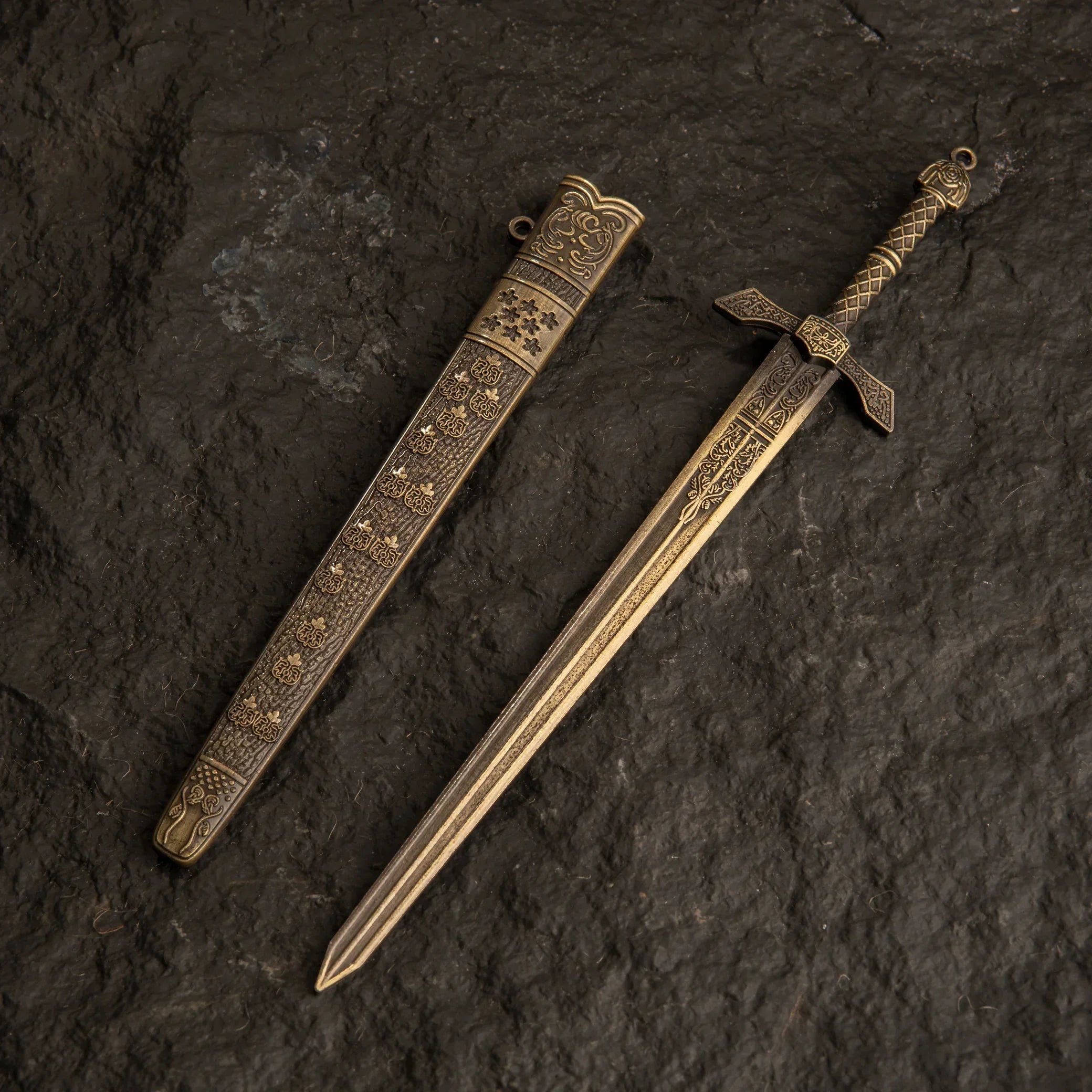 Banished Knight's Greatsword metal replica and its scabbard isolated on a dark background.