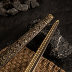 Close-up detail of the engraved patterns on the blade and scabbard of the Banished Knight's Greatsword metal replica.