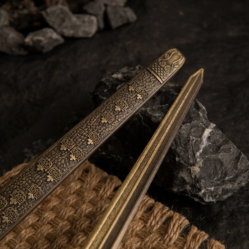 Close-up detail of the engraved patterns on the blade and scabbard of the Banished Knight's Greatsword metal replica.