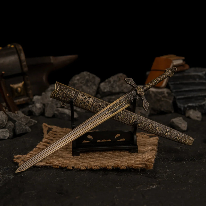 Unsheathed Banished Knight's Greatsword displayed on a small horizontal stand next to its scabbard.