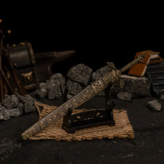 Banished Knight's Greatsword replica displayed horizontally on a small stand over a piece of burlap cloth.