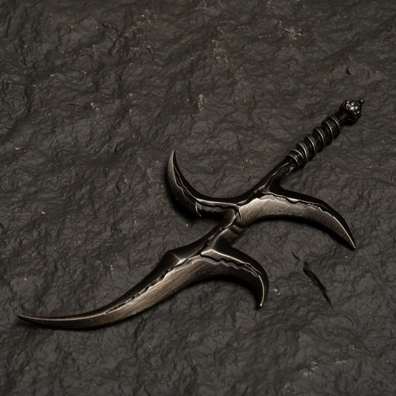 Black Knife metal replica from Elden Ring isolated on a dark grey textured background, showing its warped blade design.
