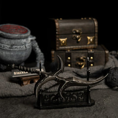 Black Knife displayed horizontally on a large black stand with a warrior jar pot prop in the background.